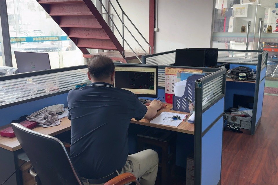 Engineers designing mold CAD drawings
